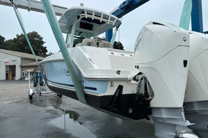 Slide: The Image of 2020 Boston Whaler 250 Outrage boat with dual engines on a lift. - 3