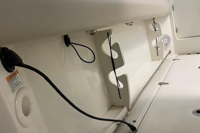 Slide: The Image of 2020 Boston Whaler 250 Outrage interior detail with storage and wiring features. - 30