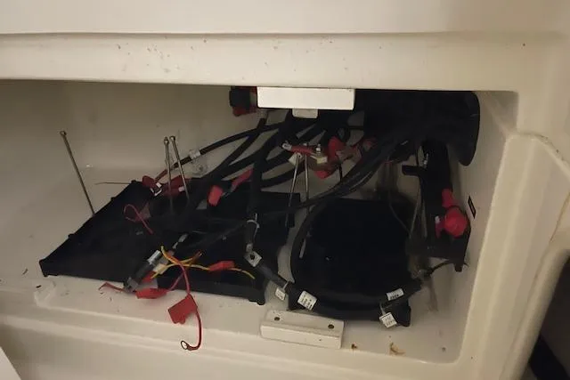 Slide: The Image of 2020 Boston Whaler 250 Outrage wiring compartment with cables and connectors. - 32
