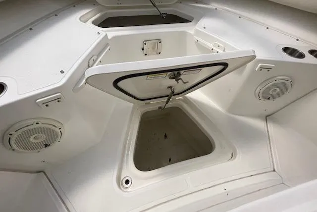 Slide: The Image of 2020 Boston Whaler 250 Outrage boat interior storage compartment with speakers and cup holders. - 36