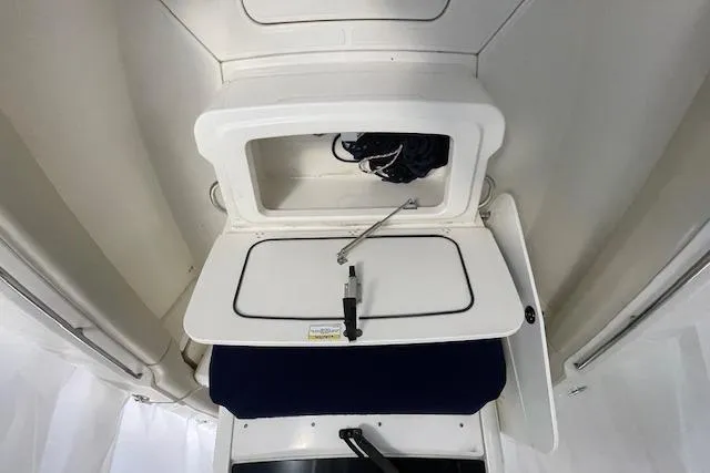 Slide: The Image of 2020 Boston Whaler 250 Outrage storage compartment with open hatch and interior view. - 37