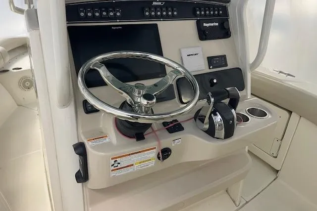 Slide: The Image of 2020 Boston Whaler 250 Outrage helm with steering wheel and control panel. - 42