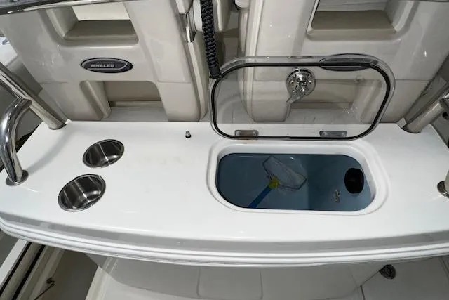 Slide: The Image of 2020 Boston Whaler 250 Outrage boat interior with livewell and cup holders. - 5
