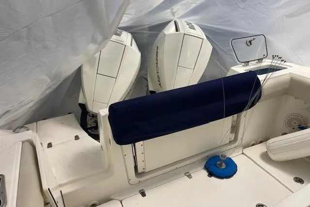 Slide: The Image of 2020 Boston Whaler 250 Outrage boat with twin Mercury engines, covered in tarp. - 51