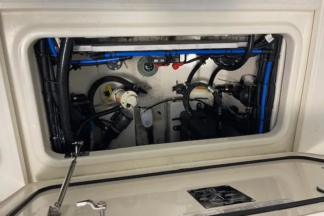 Slide: The Image of Engine compartment of a 2020 Boston Whaler 250 Outrage boat, showcasing internal components. - 55