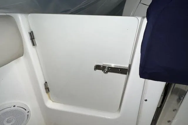 Slide: The Image of 2020 Boston Whaler 250 Outrage boat interior door with latch and speaker. - 8