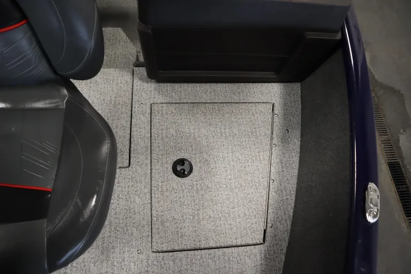 Slide: The Image of 2023 Tracker Pro Guide V-175 WT boat interior with carpeted floor and storage compartment. - 17