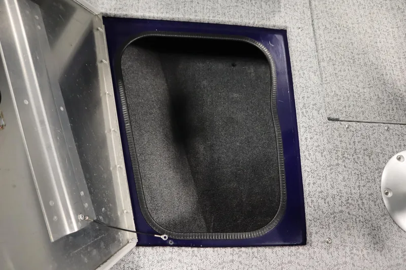 Slide: The Image of 2023 Tracker Pro Guide V-175 WT boat storage compartment with carpeted interior. - 20