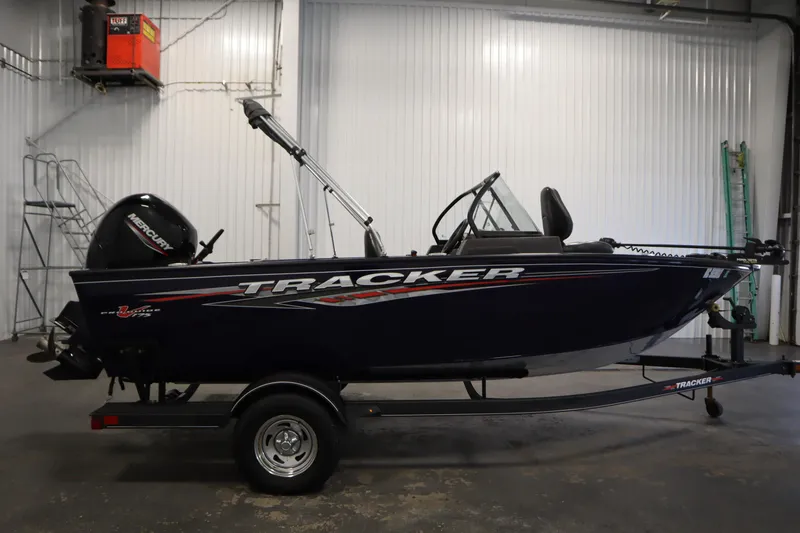 Slide: The Image of 2023 Tracker Pro Guide V-175 WT boat in a garage setting. - 4
