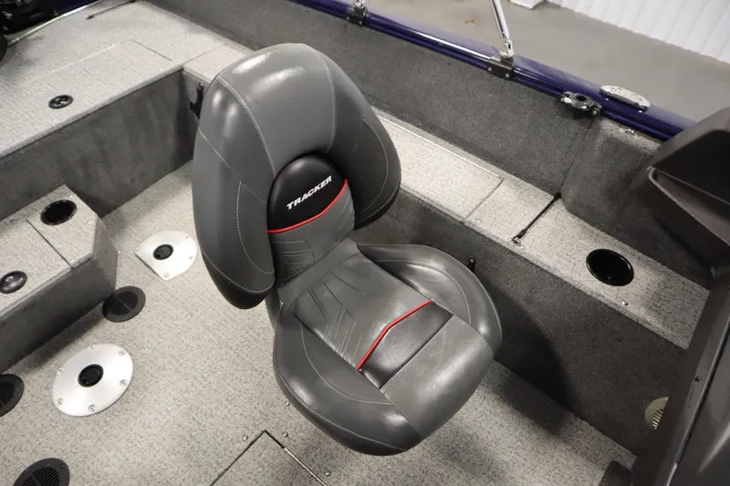 Slide: The Image of 2023 Tracker Pro Guide V-175 WT boat interior with gray seating and carpeted flooring. - 40