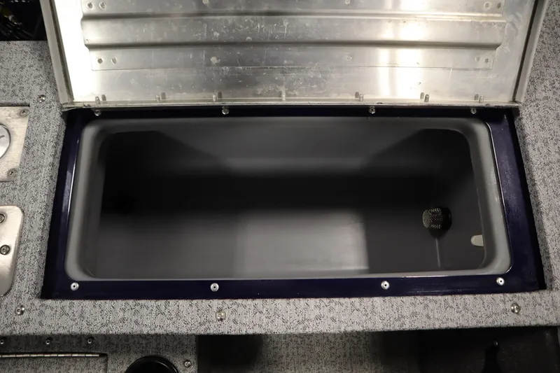 Slide: The Image of 2023 Tracker Pro Guide V-175 WT boat storage compartment, open lid, gray interior. - 48