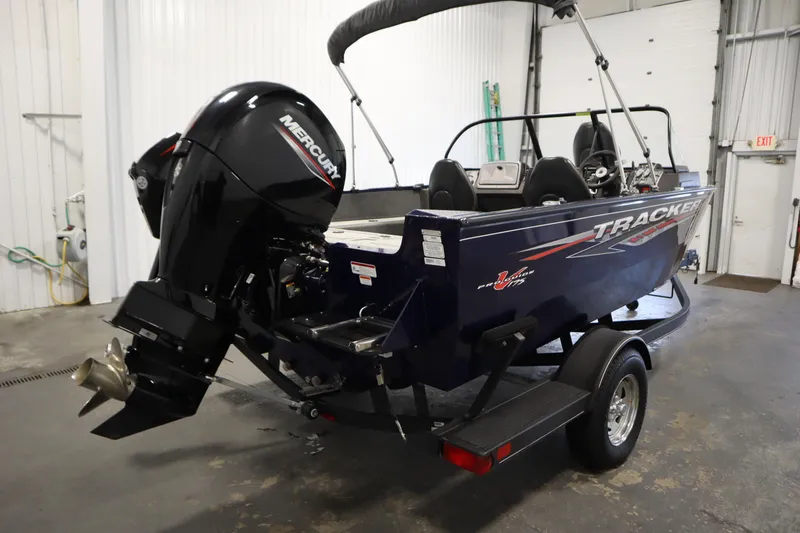 Slide: The Image of 2023 Tracker Pro Guide V-175 WT boat with Mercury outboard motor in a garage. - 5