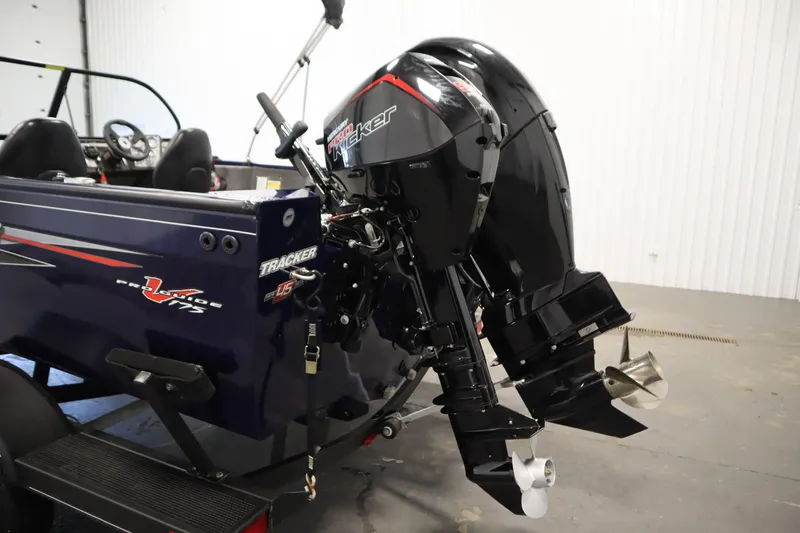 Slide: The Image of 2023 Tracker Pro Guide V-175 WT boat with powerful outboard motor in a showroom. - 53