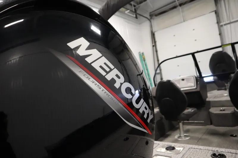 Slide: The Image of 2023 Tracker Pro Guide V-175 WT with Mercury FourStroke engine in a garage setting. - 54