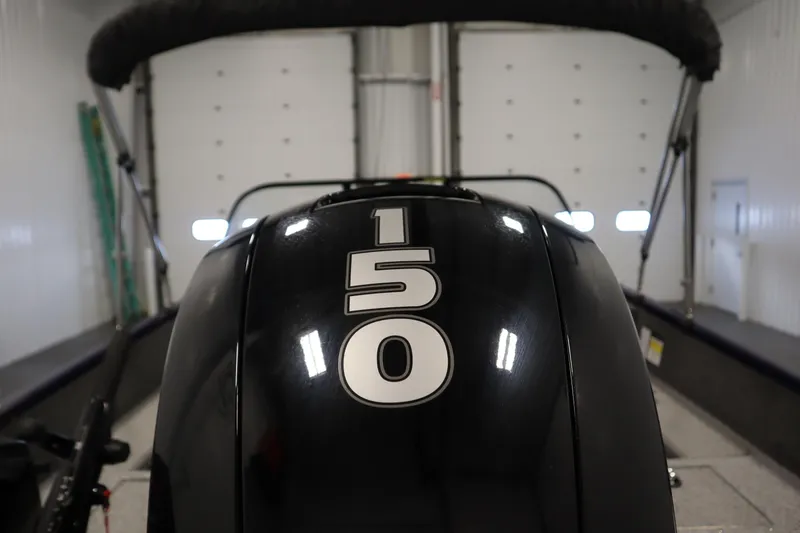 Slide: The Image of 2023 Tracker Pro Guide V-175 WT boat engine with "150" horsepower label in garage. - 55