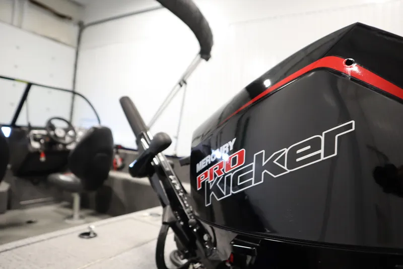 Slide: The Image of 2023 Tracker Pro Guide V-175 WT boat with Mercury Pro Kicker engine in a garage. - 56