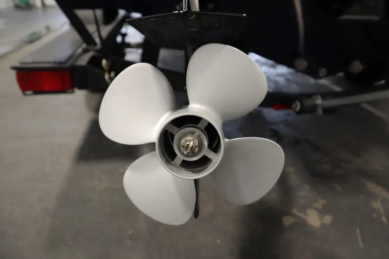 Slide: The Image of 2023 Tracker Pro Guide V-175 WT boat propeller close-up in a garage setting. - 58