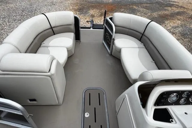 Slide: The Image of 2019 Manitou 23 Aurora LE Standard pontoon boat interior with gray seating and dashboard. - 14