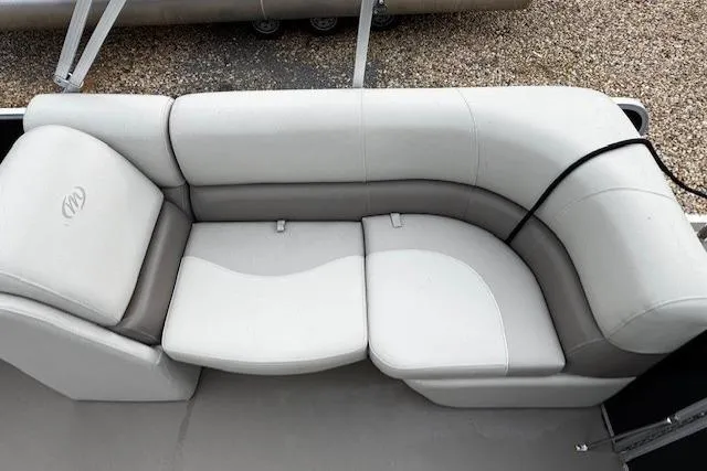 Slide: The Image of 2019 Manitou 23 Aurora LE Standard boat seating, featuring plush, curved white and gray upholstery. - 4