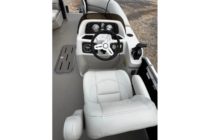 Slide: The Image of 2019 Manitou 23 Aurora LE Standard boat cockpit with steering wheel and captain's chair. - 5