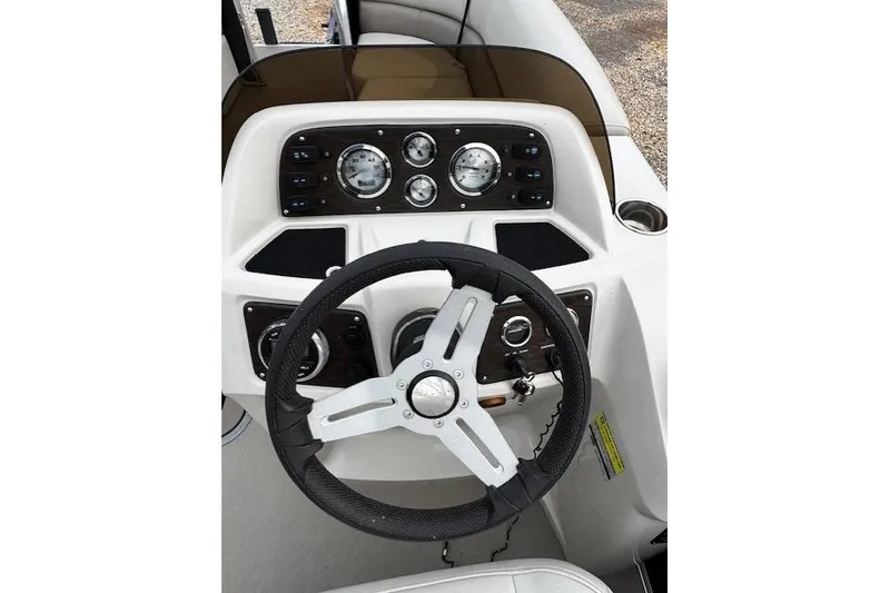 Slide: The Image of Steering console of 2019 Manitou 23 Aurora LE Standard boat with gauges and controls. - 8