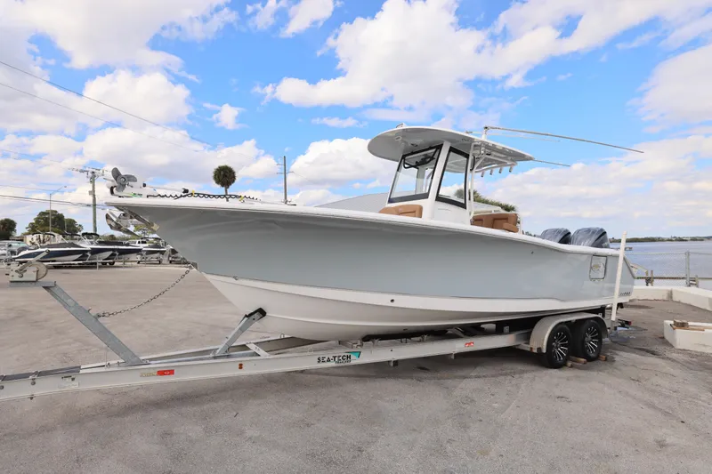Slide: The Image of 2022 Sea Hunt Gamefish 27 boat on trailer under blue sky. - 11