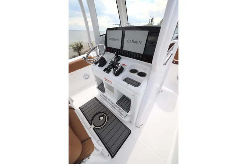 Slide: The Image of 2022 Sea Hunt Gamefish 27 helm with Garmin displays and modern controls. - 13