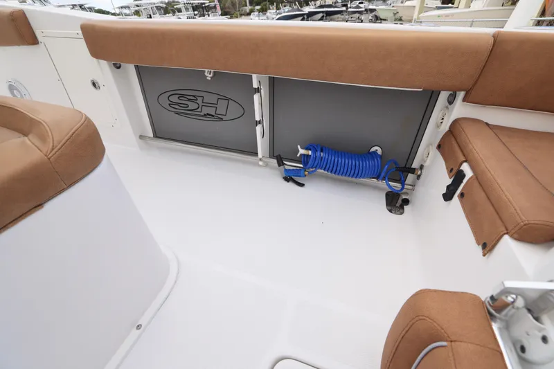 Slide: The Image of 2022 Sea Hunt Gamefish 27 Forward Seating with tan upholstery and storage compartment. - 16