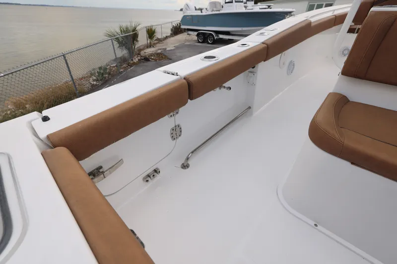 Slide: The Image of 2022 Sea Hunt Gamefish 27 Forward Seating boat interior with brown cushioned seats. - 17