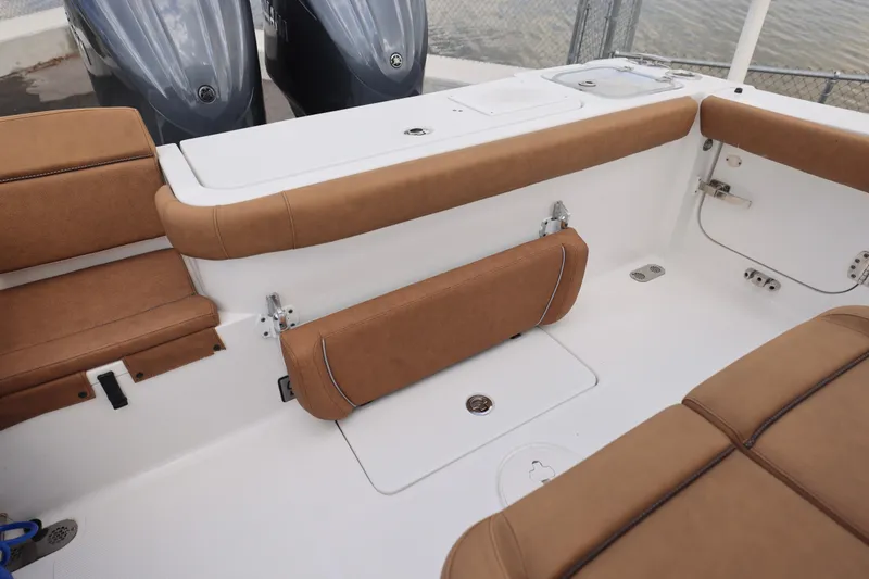 Slide: The Image of 2022 Sea Hunt Gamefish 27 boat interior with tan seating and dual engines. - 18