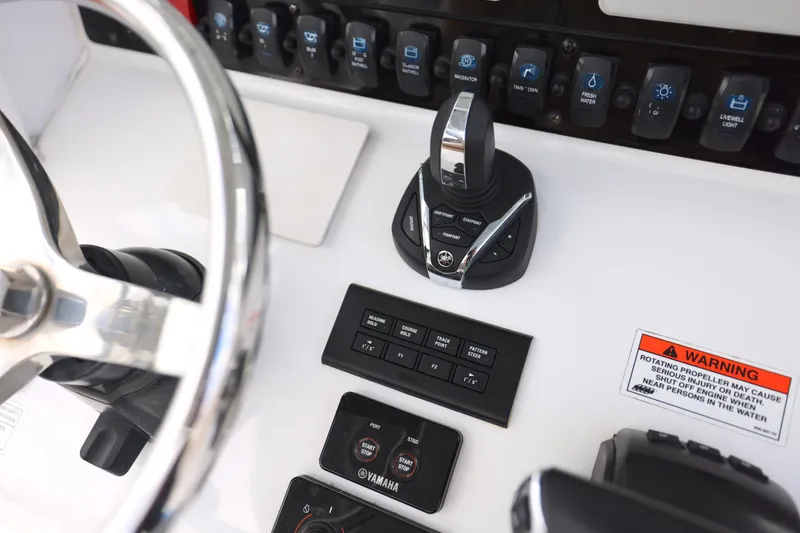 Slide: The Image of Control panel of 2022 Sea Hunt Gamefish 27 boat with steering wheel and Yamaha controls. - 2