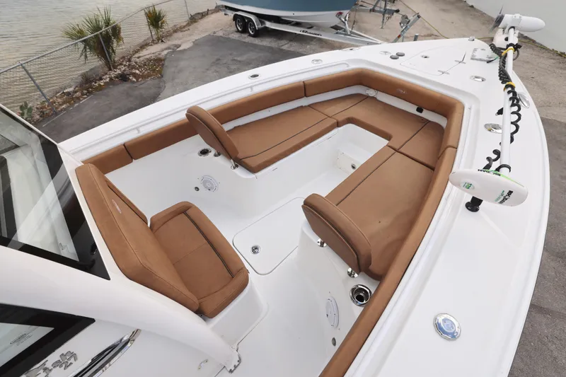 Slide: The Image of 2022 Sea Hunt Gamefish 27 Forward Seating with tan cushions and spacious deck layout. - 27