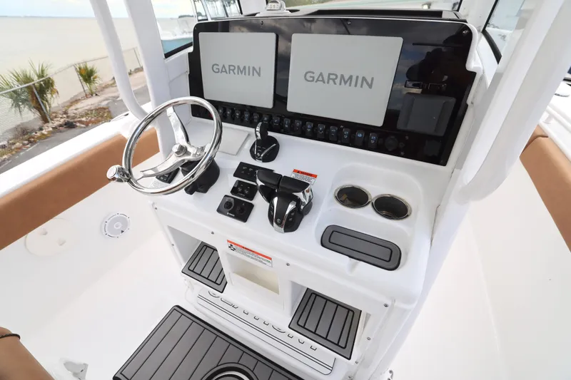 Slide: The Image of 2022 Sea Hunt Gamefish 27 helm with Garmin displays and modern controls. - 3