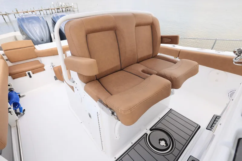 Slide: The Image of 2022 Sea Hunt Gamefish 27 boat with tan forward seating and dual engines. - 6