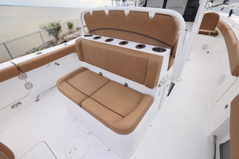 Slide: The Image of 2022 Sea Hunt Gamefish 27 Forward Seating with tan cushioned seats and cup holders. - 7