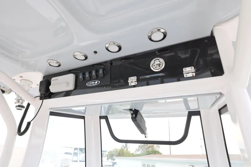 Slide: The Image of 2022 Sea Hunt Gamefish 27 Forward Seating console with electronics and storage compartment. - 9