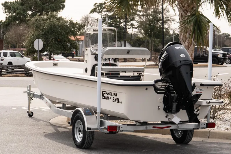 Slide: The Image of 2026 Carolina Skiff E20 JVX CC boat on trailer, parked outdoors. - 4