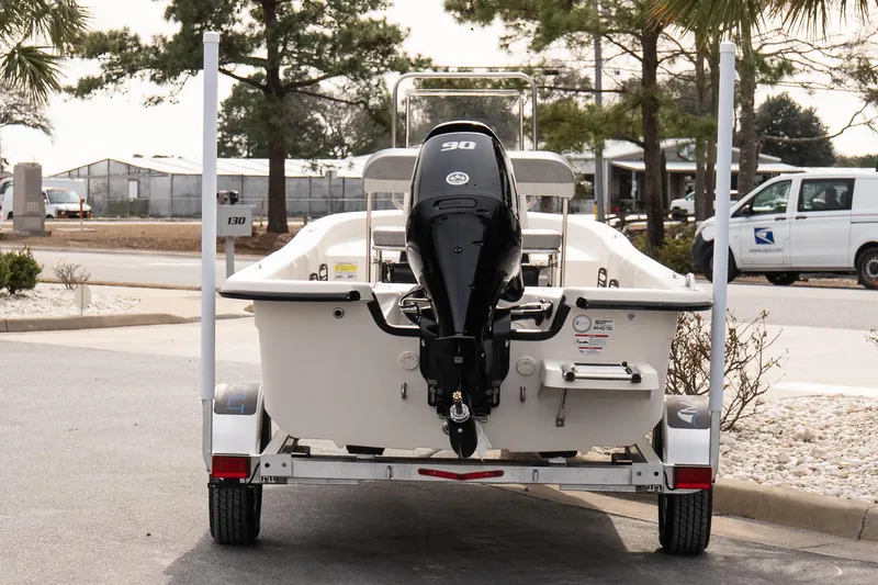 Slide: The Image of 2026 Carolina Skiff E20 JVX CC boat on trailer, rear view with outboard motor. - 5
