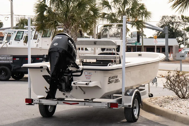 Slide: The Image of 2026 Carolina Skiff E20 JVX CC boat on trailer with Suzuki engine, parked outdoors. - 6