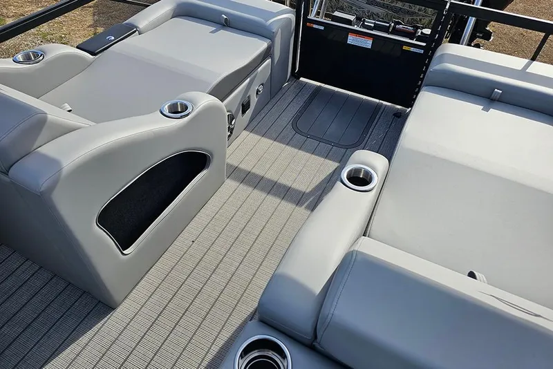 Slide: The Image of 2026 SunCatcher Fusion 324SS interior with gray seating and cup holders. - 10