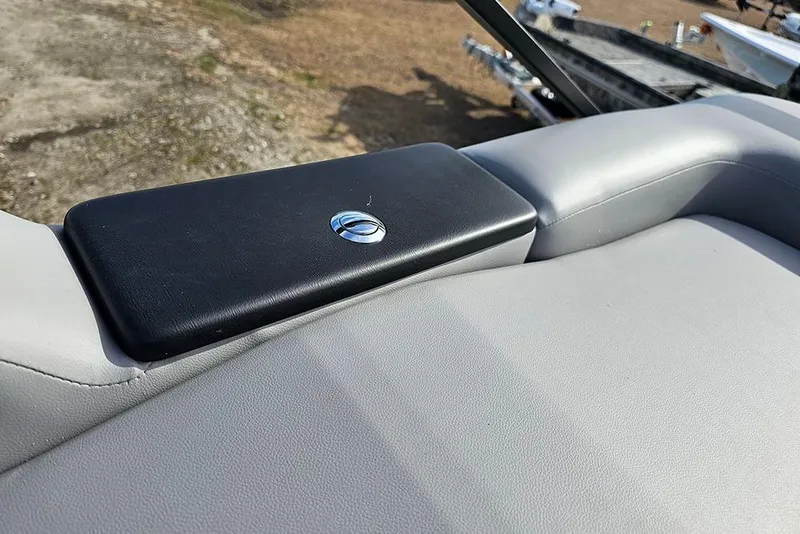 Slide: The Image of 2026 SunCatcher Fusion 324SS boat seat detail with black armrest and logo. - 13
