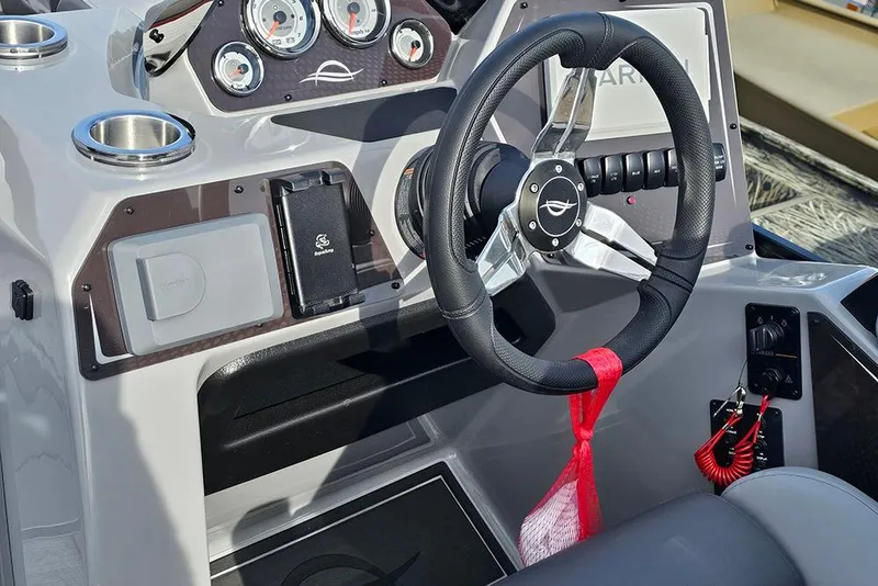 Slide: The Image of 2026 SunCatcher Fusion 324SS boat dashboard with steering wheel and gauges. - 23