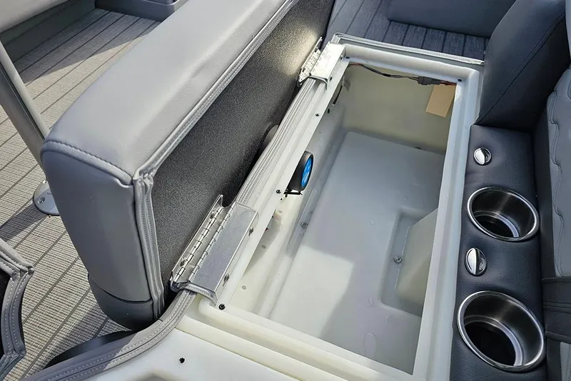 Slide: The Image of 2026 SunCatcher Fusion 324SS boat storage compartment with cup holders and cushioned seating. - 28