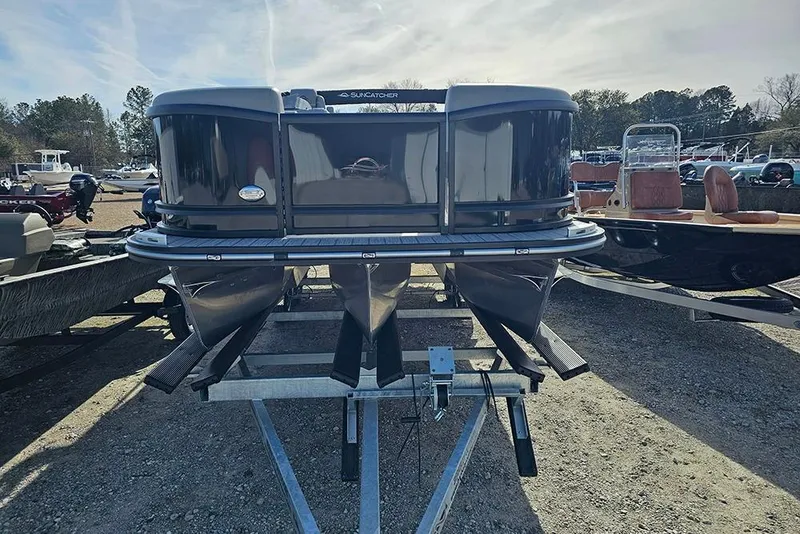 Slide: The Image of 2026 SunCatcher Fusion 324SS pontoon boat on trailer, displayed outdoors. - 3