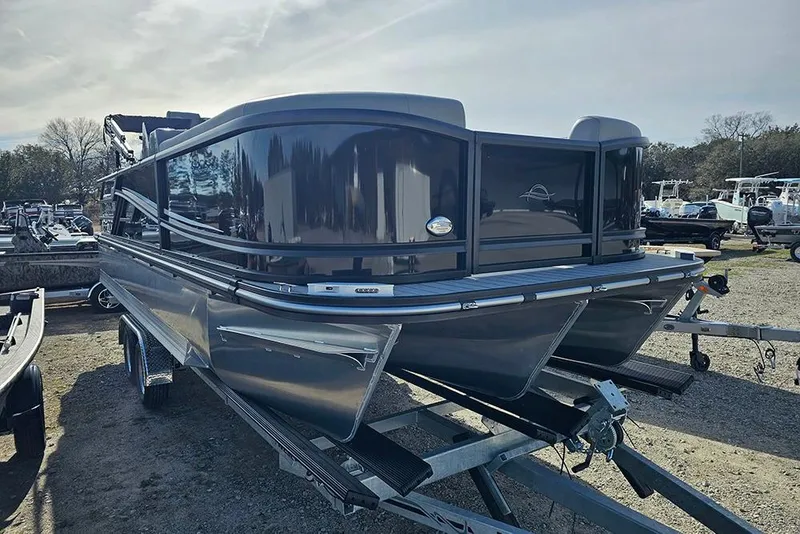 Slide: The Image of 2026 SunCatcher Fusion 324SS pontoon boat on trailer, sleek design, outdoor setting. - 4