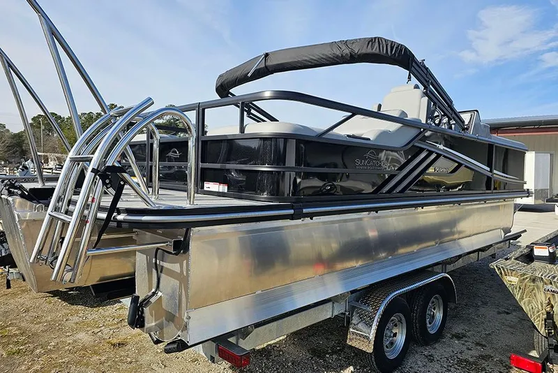 Slide: The Image of 2026 SunCatcher Fusion 324SS pontoon boat on a trailer, featuring sleek design and modern amenities. - 5