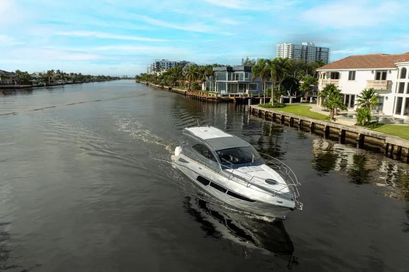 Slide: The Image of 2025 Valiatt 410HT luxury yacht cruising along a scenic waterfront. - 2