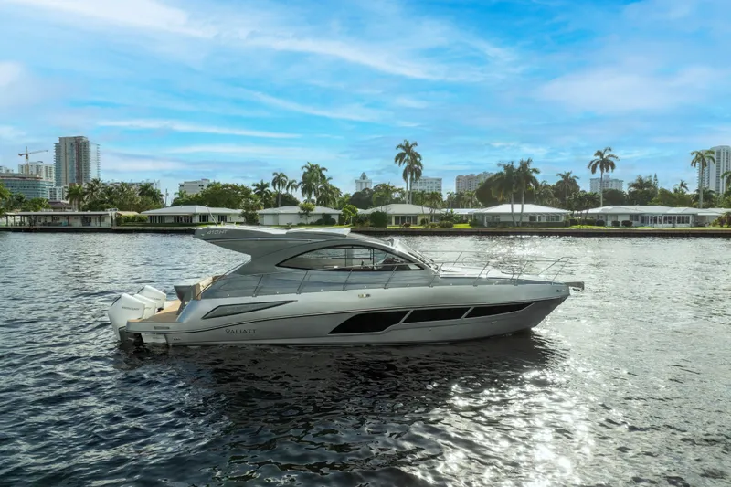 Slide: The Image of 2025 Valiatt 410HT yacht on a sunny waterfront with palm trees and cityscape. - 29