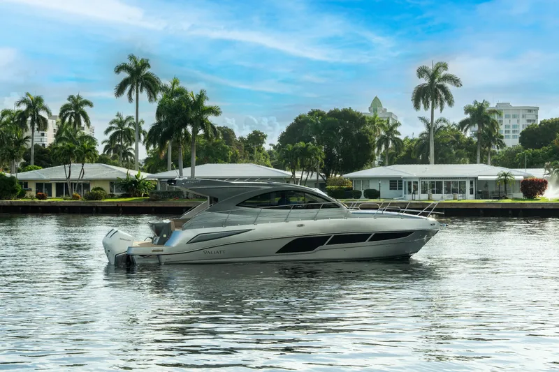 Slide: The Image of Luxury Valiatt 410HT yacht cruising on a serene waterway, surrounded by palm trees, 2025 model. - 32