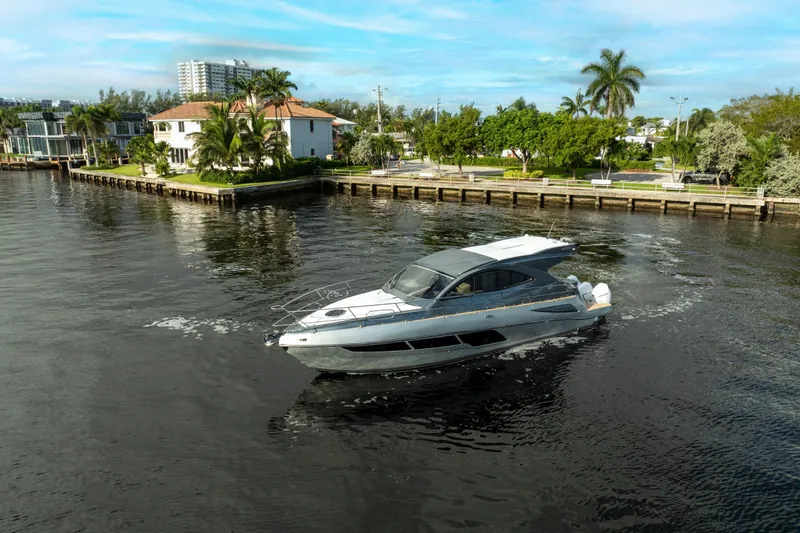 Slide: The Image of 2025 Valiatt 410HT luxury yacht cruising near waterfront homes, surrounded by lush greenery. - 4